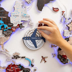 Hand placing a travel pin on a map with an airplane symbol and 'Countries visited' text.