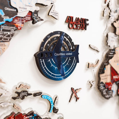 Travel-themed decorative items including a compass and map cutouts on a white background.