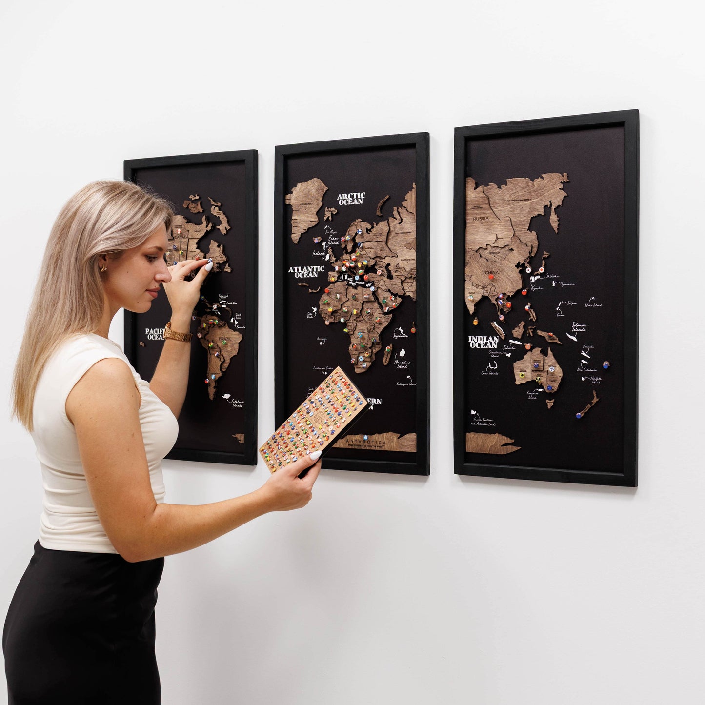 Woman interacting with a world map on a wall