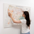 Woman interacting with a world map on a wall