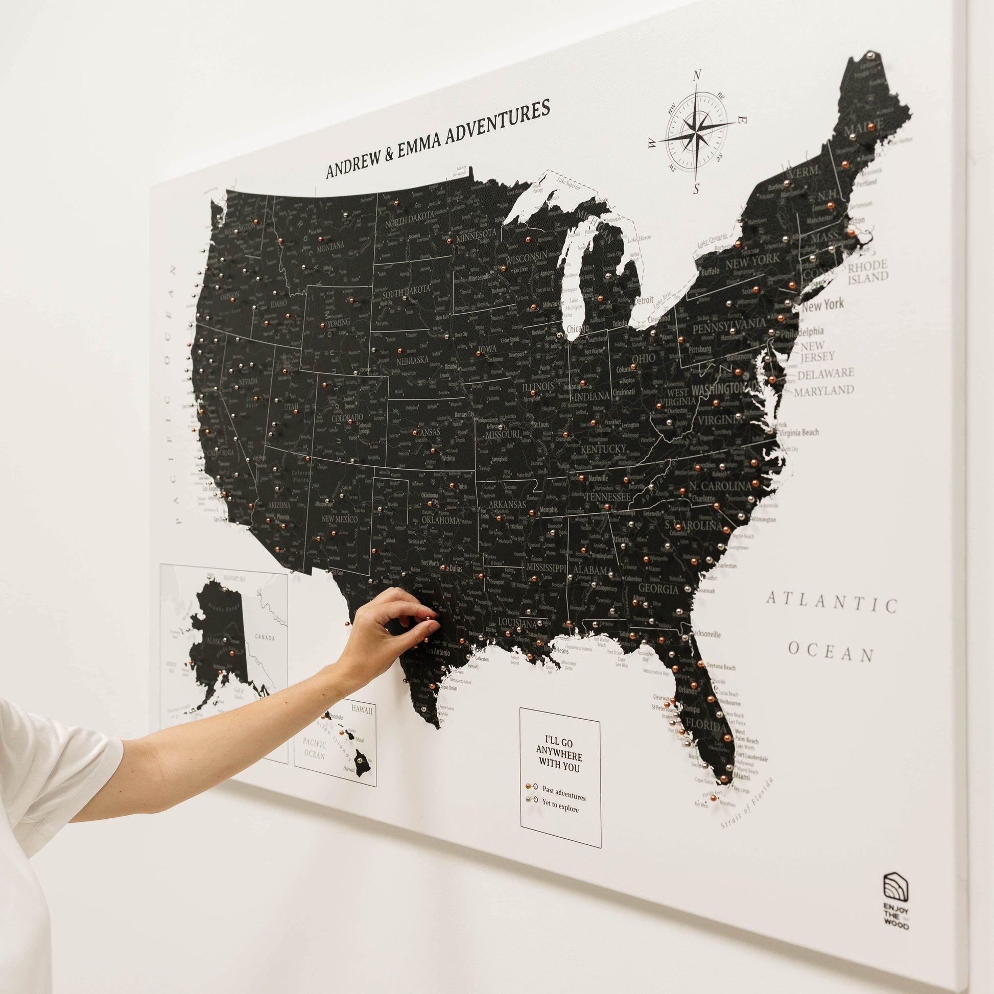 Map of the United States with a hand scratching off a location on a white background