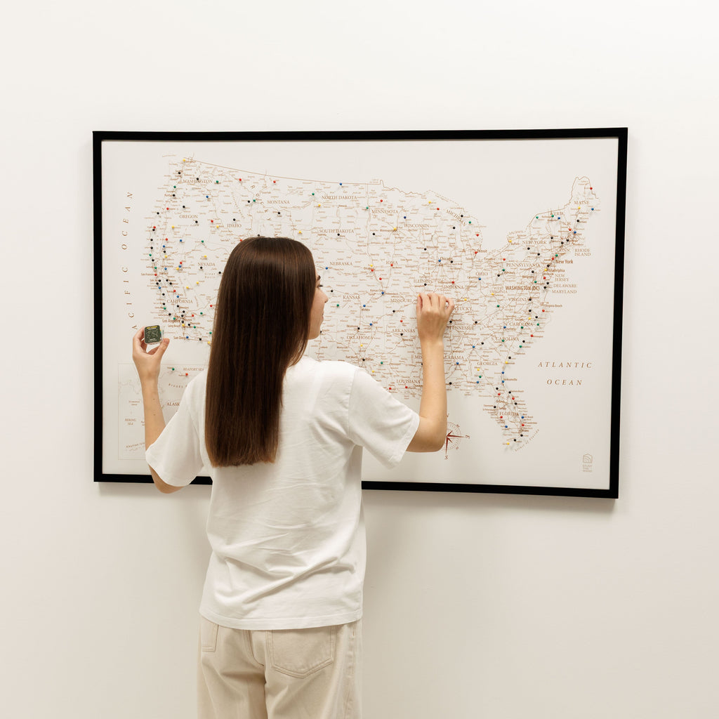 Person interacting with a map on a wall