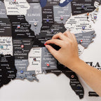 Hand interacting with a puzzle map of the United States on a white background
