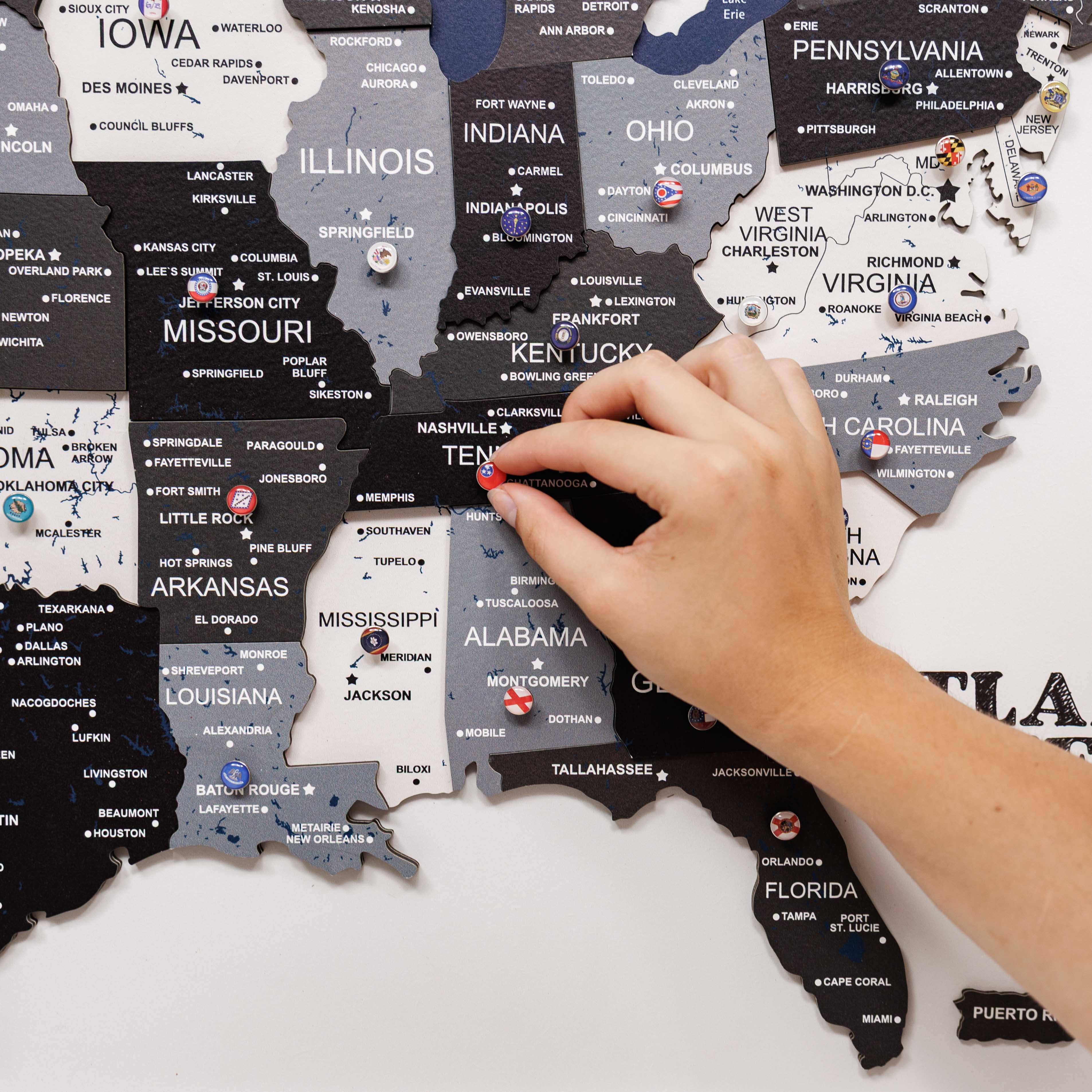 Hand interacting with a puzzle map of the United States on a white background