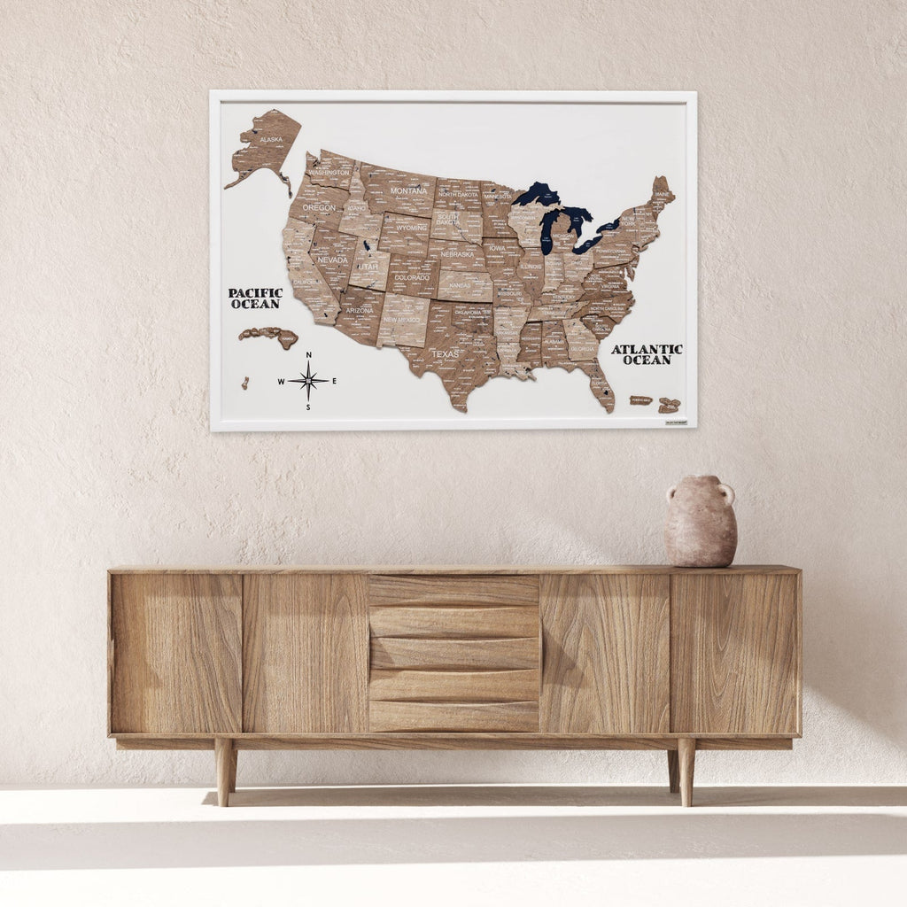 Wooden map of the United States on a wall above a wooden cabinet.