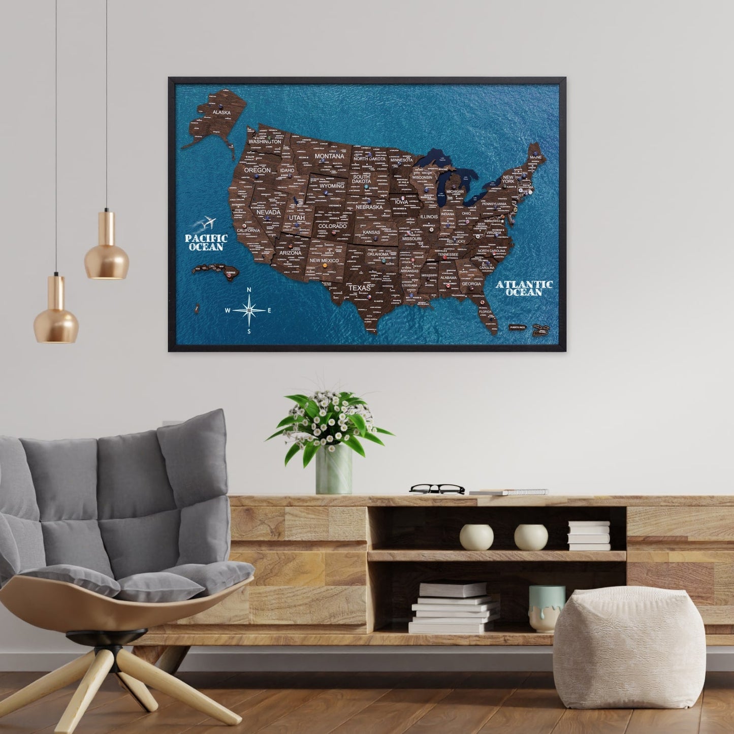 Framed map of the United States on a wall in a living room with a sofa and coffee table.