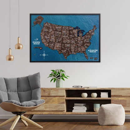 Framed map of the United States on a wall in a living room with a sofa and coffee table.