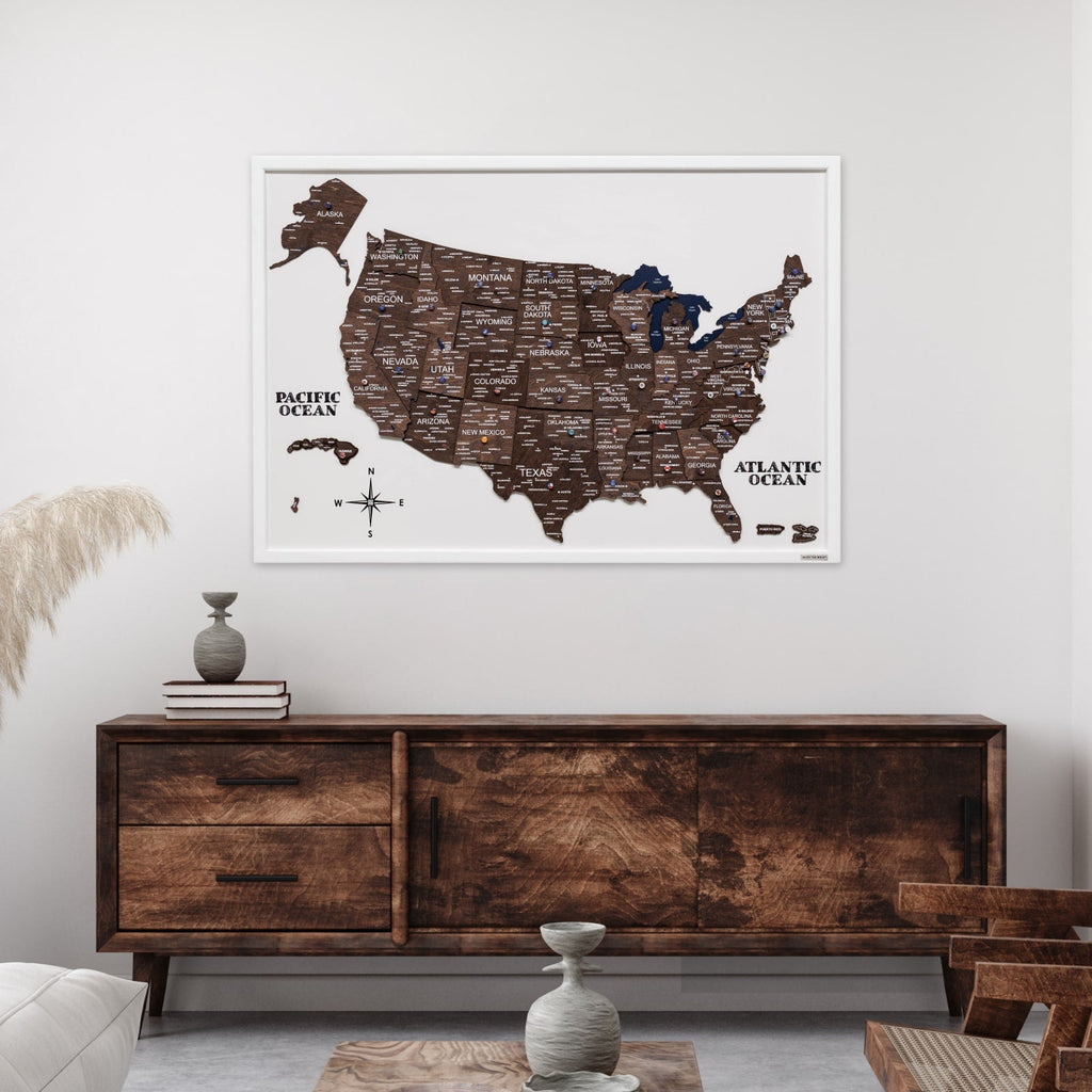 Framed map of the United States on a wall above a wooden sideboard.