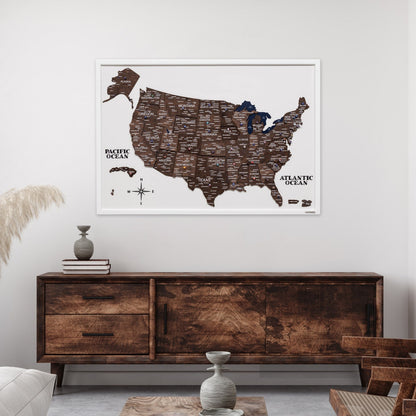 Framed map of the United States on a wall above a wooden sideboard.