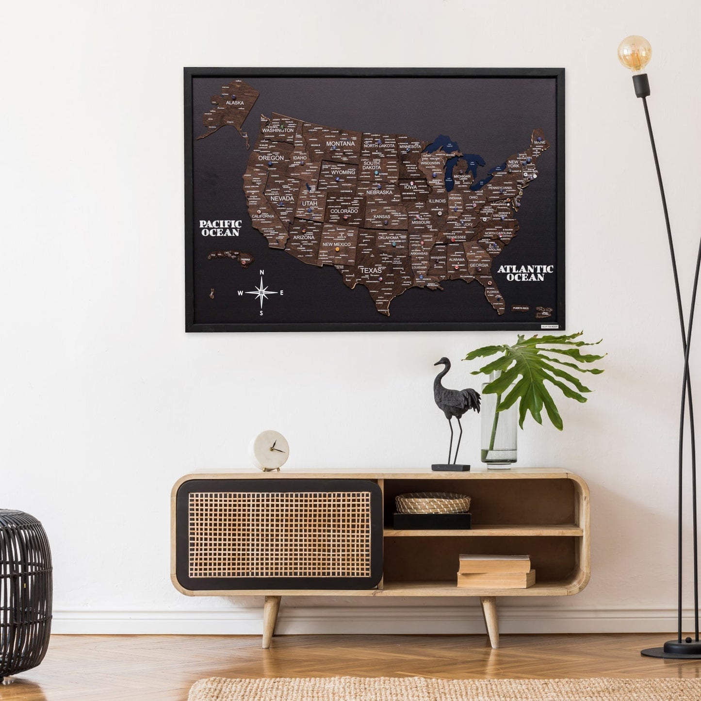 Framed map of the United States on a wall above a wooden console table with decorative items.