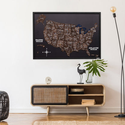 Framed map of the United States on a wall above a wooden console table with decorative items.