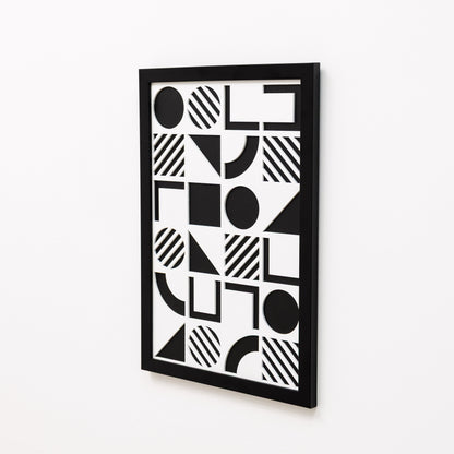 Black and white geometric patterned wall art on a white background