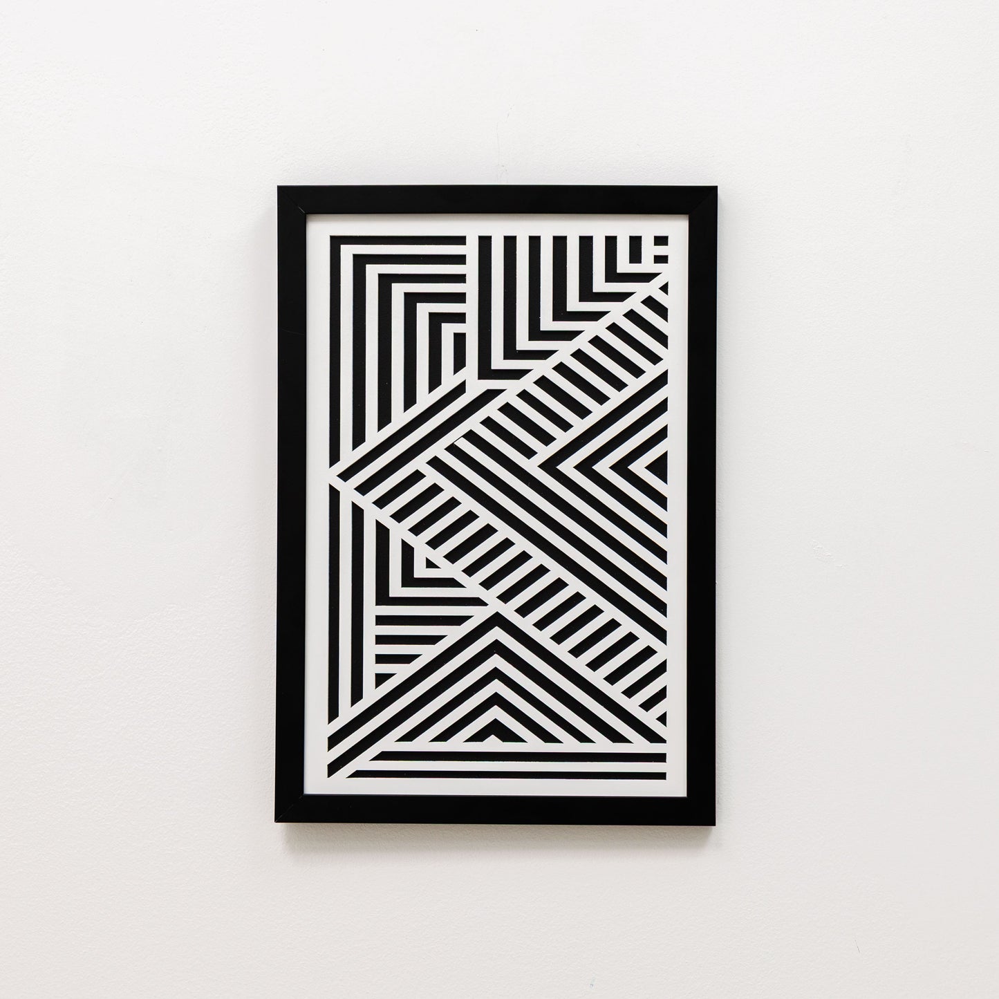 Framed black and white geometric art on a white background