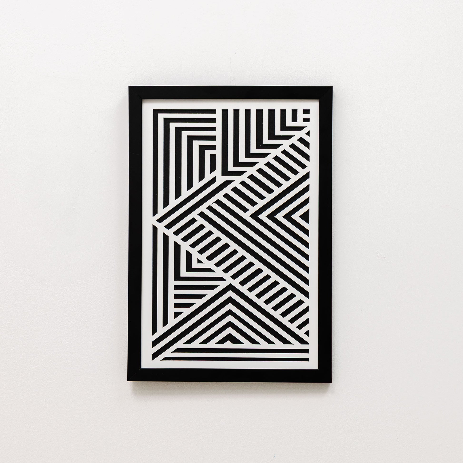 Framed black and white geometric art on a white background