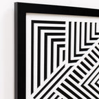 Framed black and white geometric pattern on a white wall