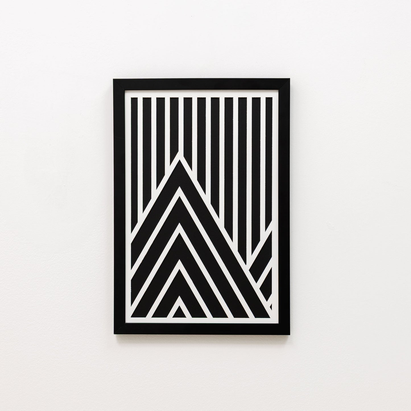 Framed black and white geometric art print on a light gray background