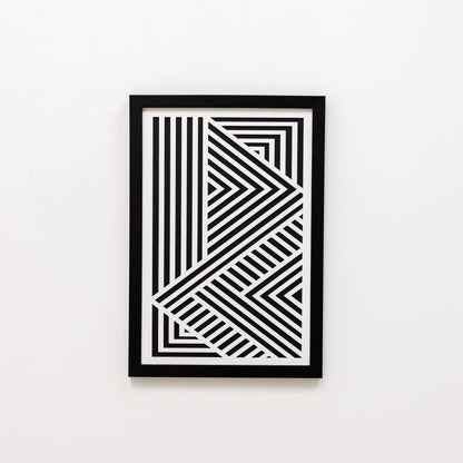 Framed black and white geometric art print on a white wall