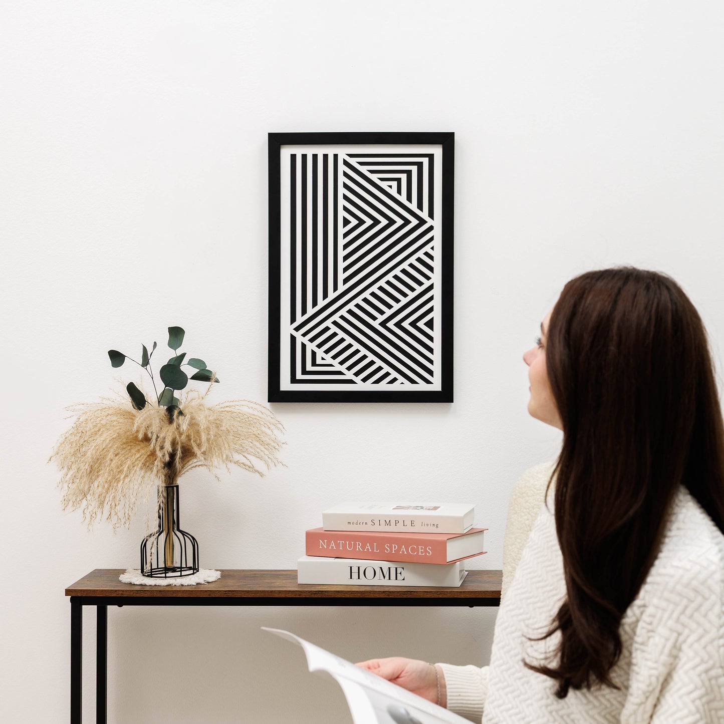Woman looking at a geometric art print on a wall