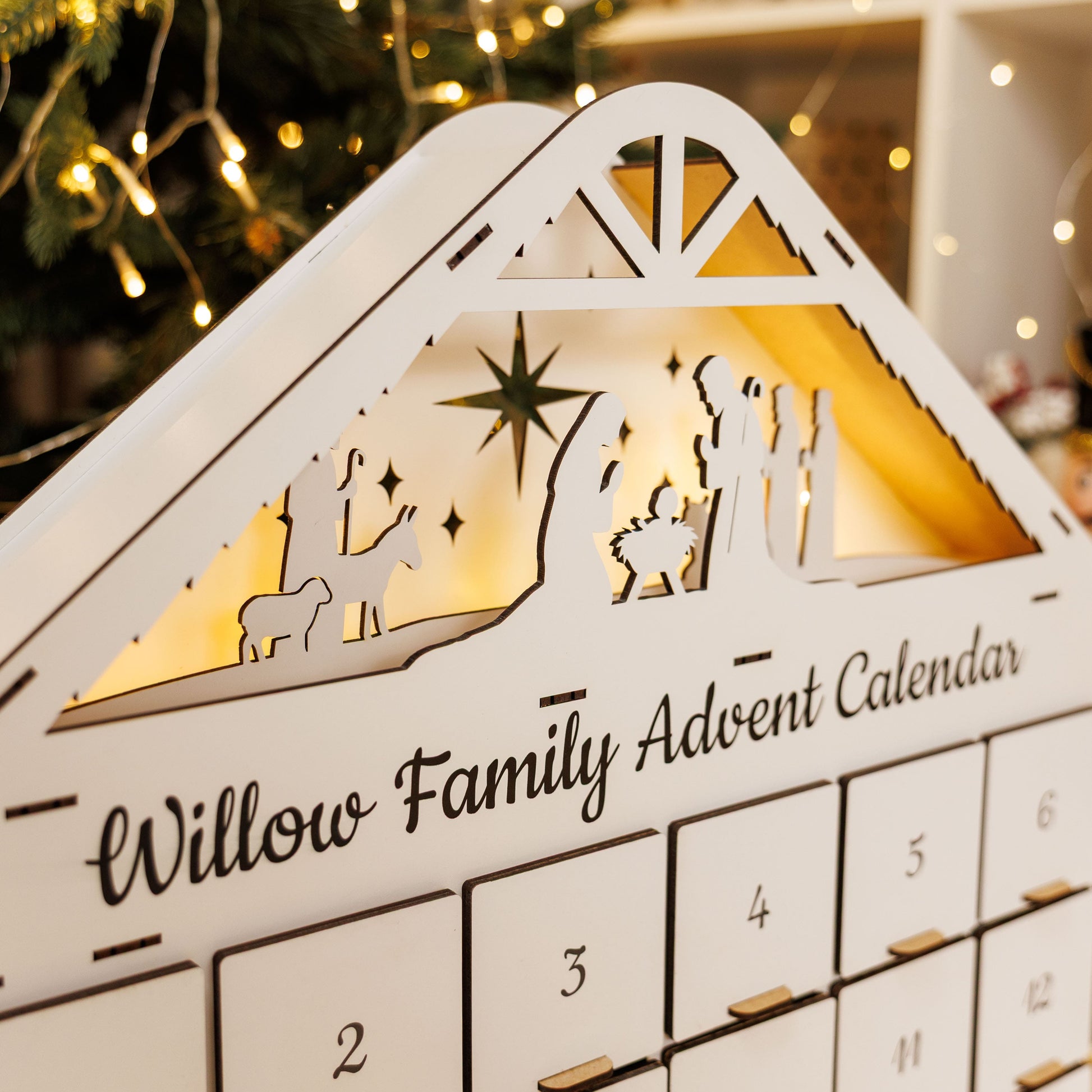 Willow Family Advent Calendar with Christmas tree and lights in the background