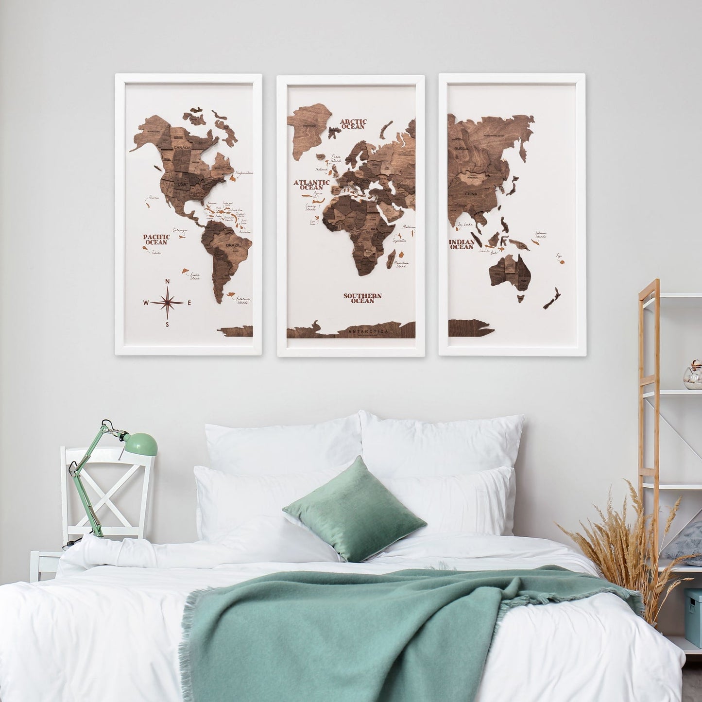 World map posters on a wall above a bed in a bedroom