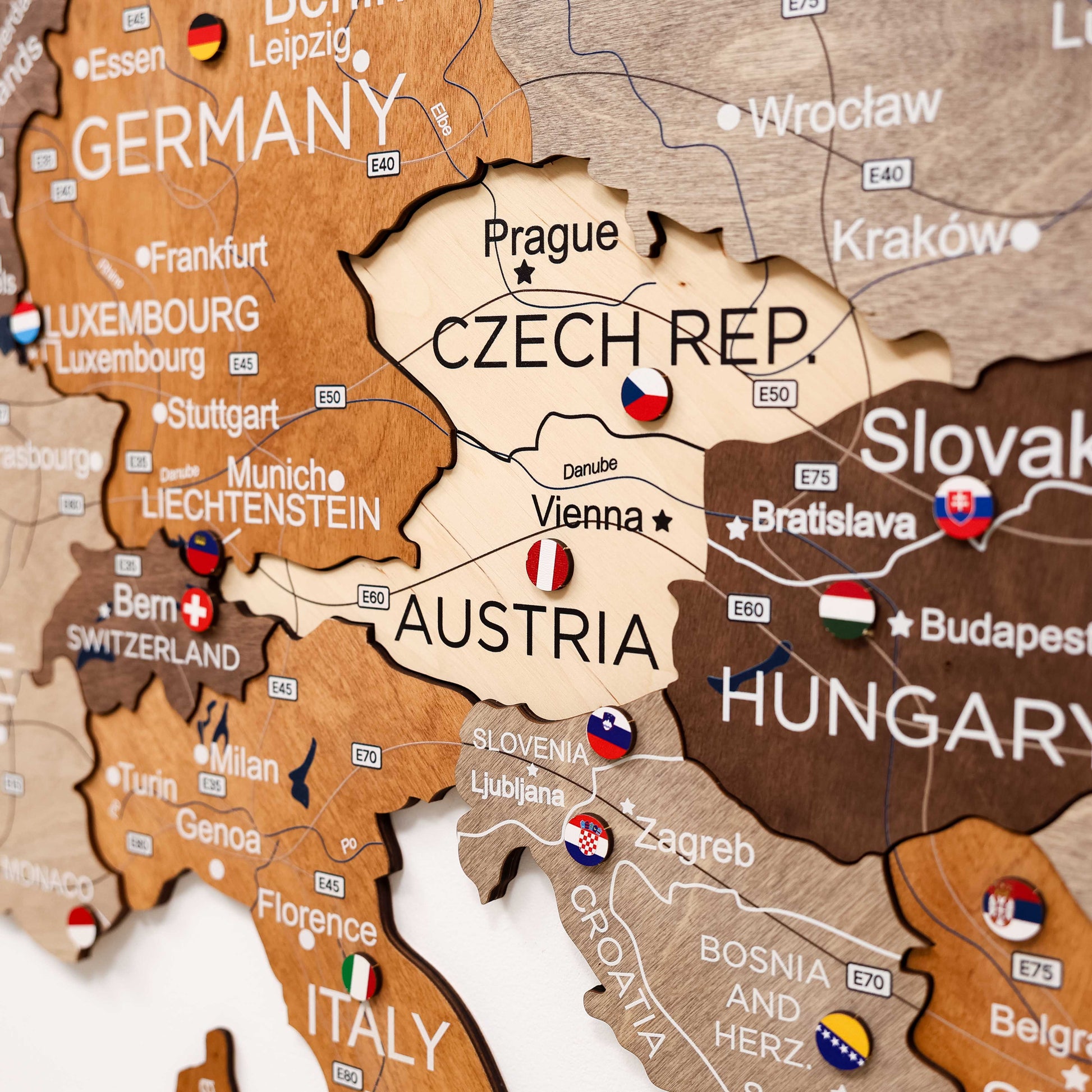 Map of Central Europe with country names and flags on a wooden surface